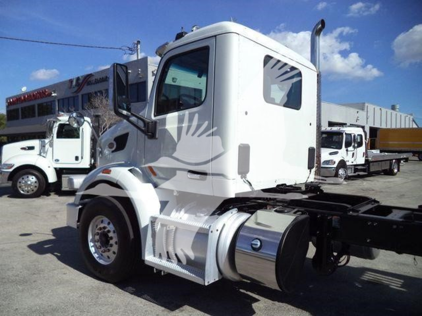 2016 Peterbilt 567 rollback truck cab and chassis visible with fuel tank, exhaust stack, and side mirror.