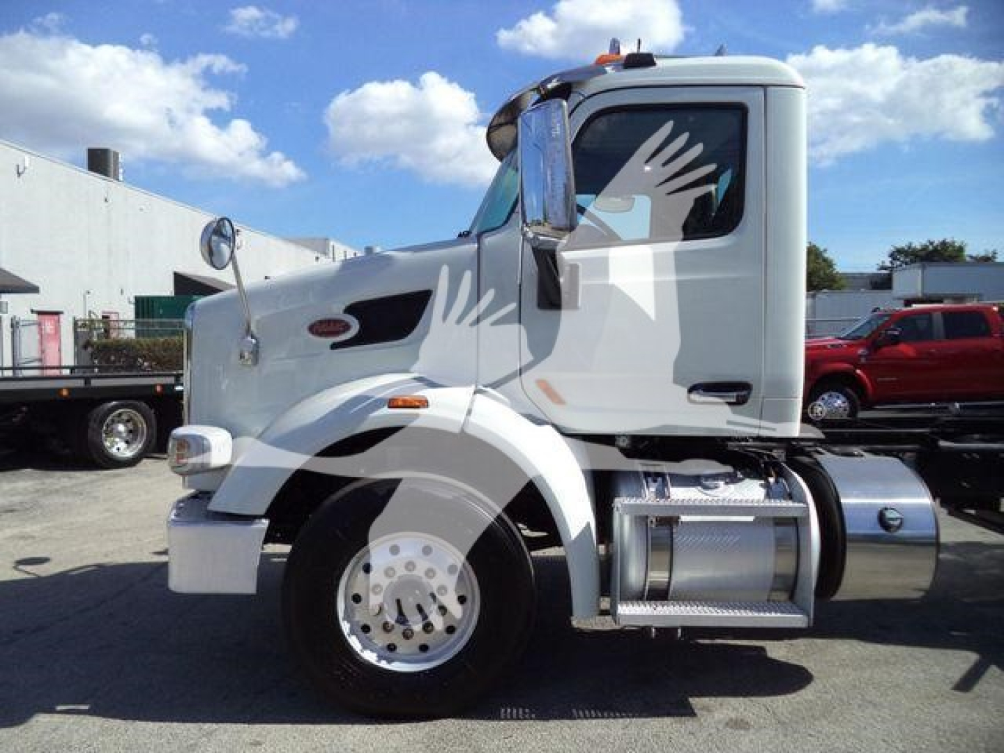 Peterbilt 567 rollback truck side view showing cab and fuel tank, 2016 model, stock T01476FM.