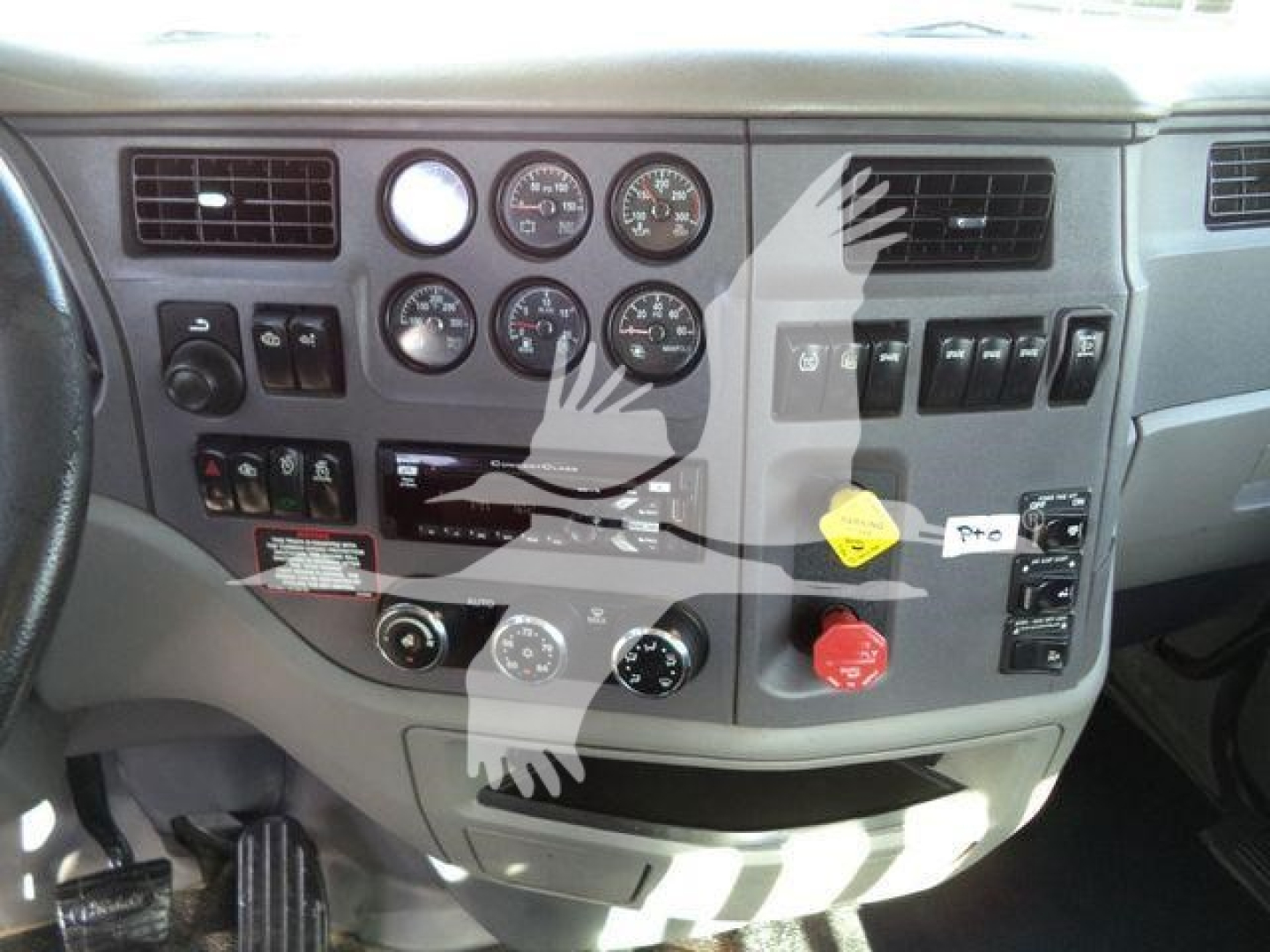 Peterbilt truck dashboard with multiple gauges, switches, and knobs in a 2016 Peterbilt 567 cab interior.