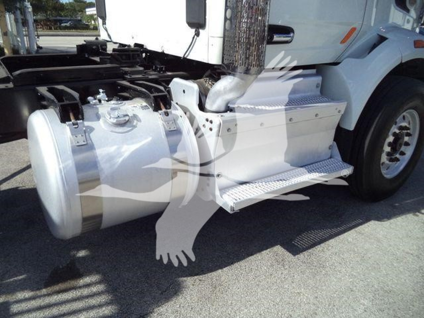 Truck side view showing fuel tank and side stairs on a Peterbilt 567 cab with chrome steps and wheel, undercarriage visible.
