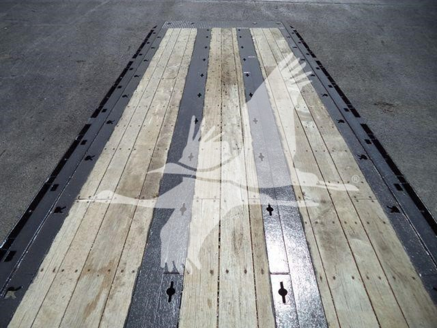Peterbilt 567 rollback truck bed with wooden planks and metal strips showing load deck