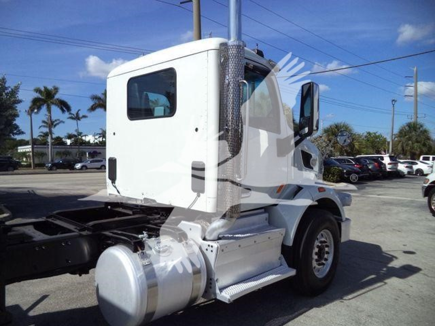 Peterbilt 567 rollback truck cab and chassis side view showing step, fuel tanks, and exhaust stack
