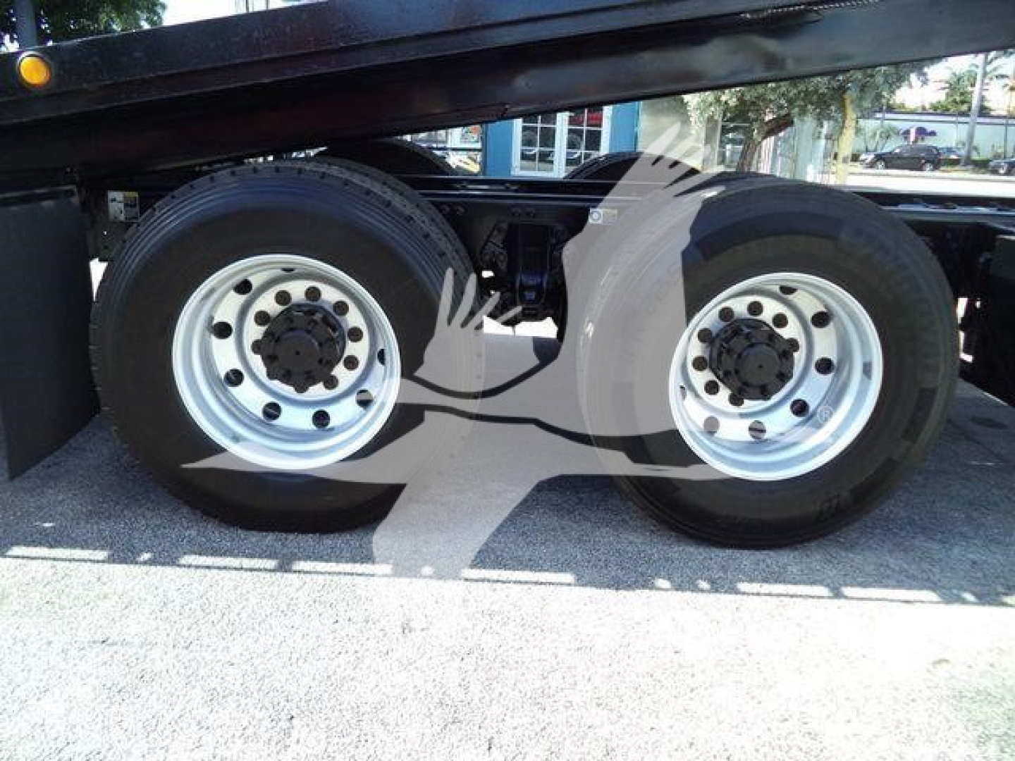 Peterbilt 567 rollback truck dual rear axles wheels with silver rims and black tires showing undercarriage.