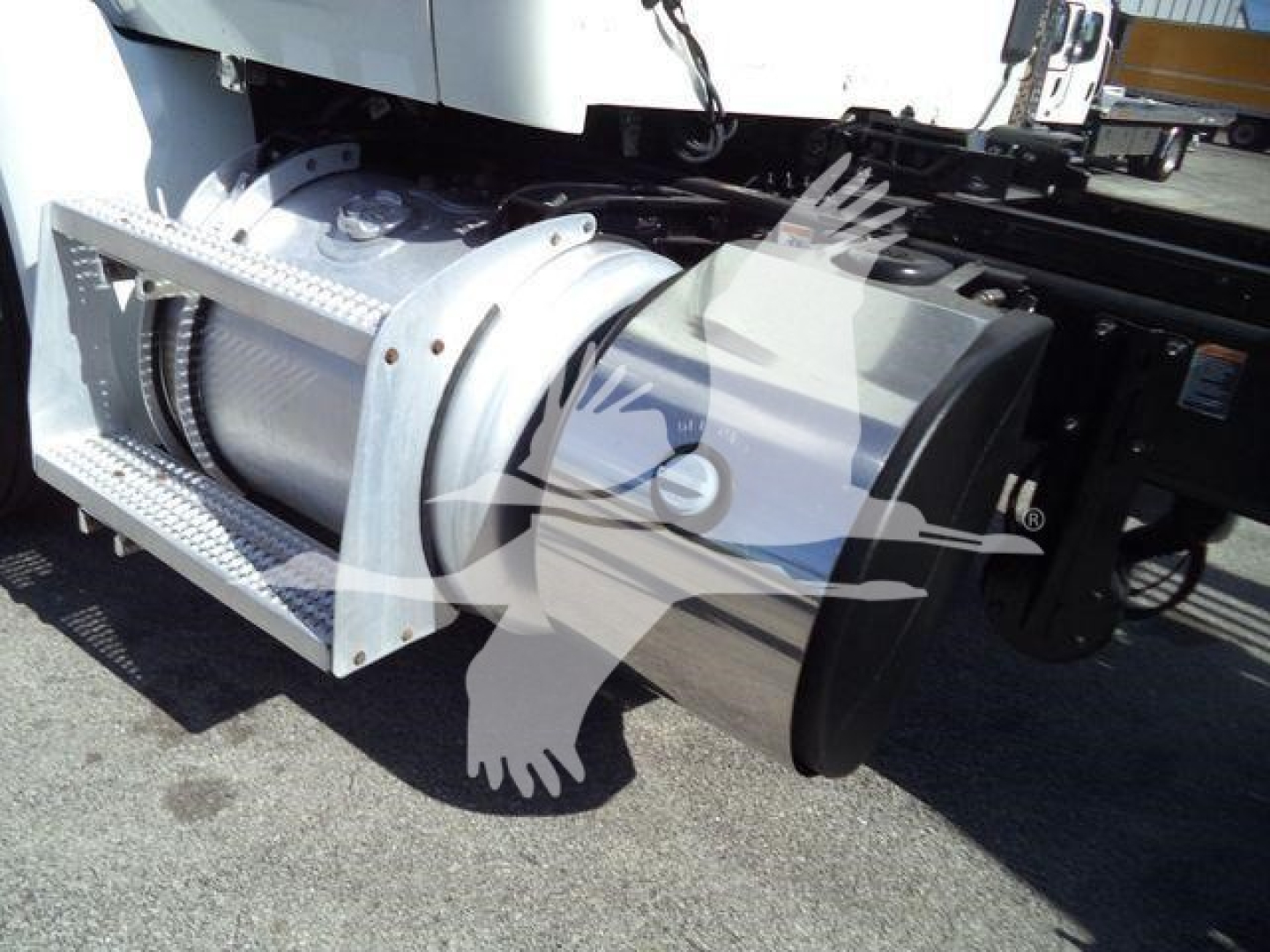 Peterbilt 567 rollback truck showing drivetrain component and side air intake with metal step.