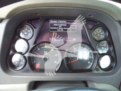 Instrument cluster of a Peterbilt 567 dashboard with multiple gauges and a central display screen.