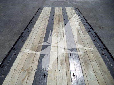 Peterbilt 567 rollback truck bed with wooden planks and metal strips showing load deck