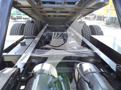 Peterbilt 567 rollback chassis undercarriage forward view showing dual rear axles and frame rails