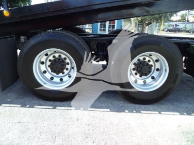 Peterbilt 567 rollback truck dual rear axles wheels with silver rims and black tires showing undercarriage.
