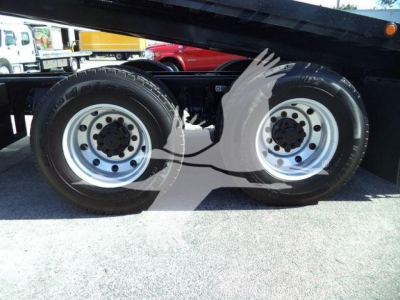 Dual rear wheels of a Peterbilt 567 rollback trailer showing aluminum rims and tires
