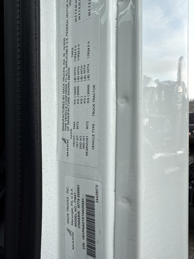 Label on Mack PI64T truck showing vehicle specs and VIN plate details (text visible on sticker).