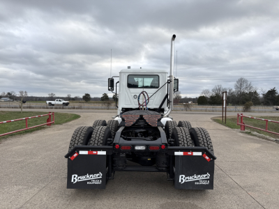 Rear view of a new 2026 Mack PI64T conventional daycab truck showing dual rear wheels and mud flaps with Bruckner's Equipment logos.