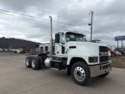 Mack PI64T truck exterior side view showing cab, long chassis, dual rear axles, vertical exhaust stack, and front grille with Mack emblem.