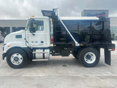 Mack MD7 dump truck side view showing dump bed and chassis with white cab and black container.