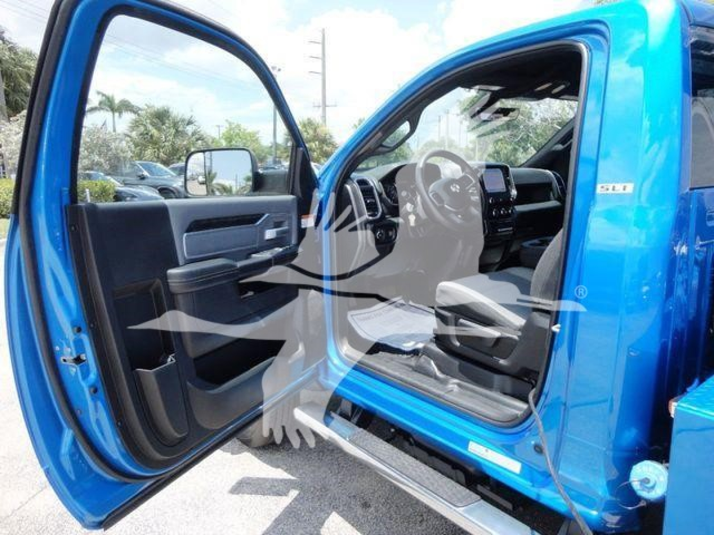 Ram 4500 SLT truck interior with front doors open, showing black and gray cabin, steering wheel, and dashboard from driver side.