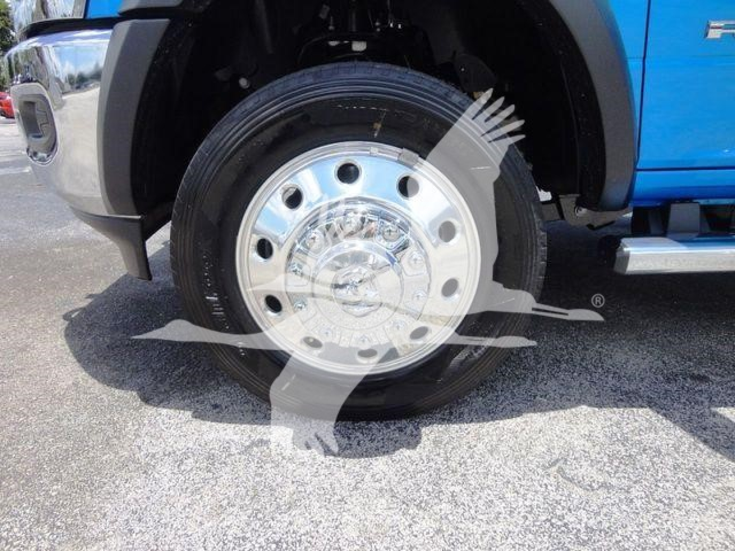 Truck front wheel and chrome hubcap on Ram 4500 SLT, close-up view of front left tire and fender