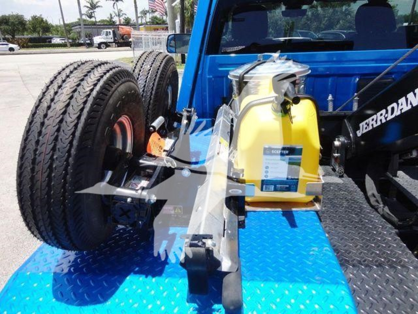 Ram 4500 SLT truck bed showing dual rear wheels and yellow windshield washer/def tank, winch components, and metal frame in blue truck bed.