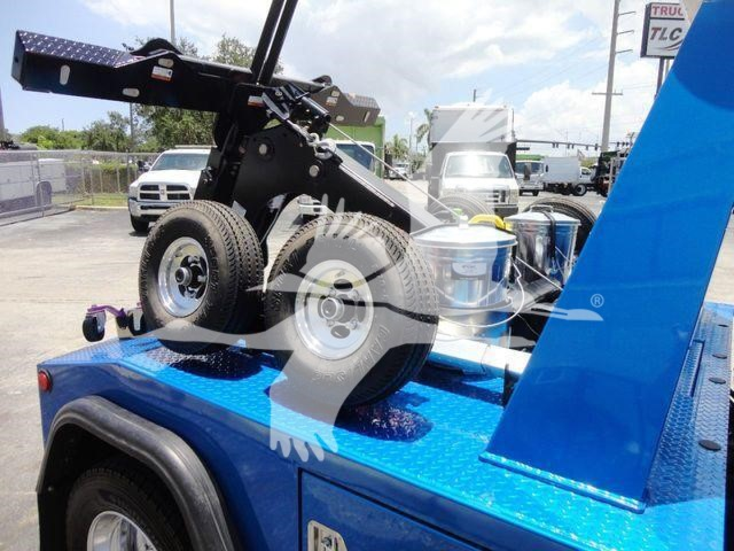 Ram 4500 truck chassis with wheel and winch mount showing blue flatbed and hydraulic equipment.