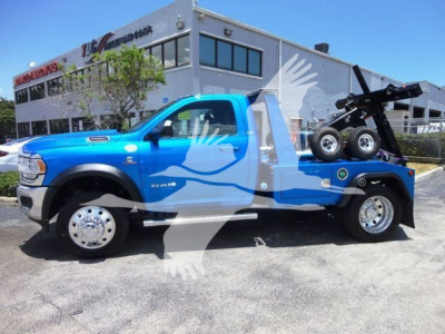 Blue 2024 Ram 4500 SLT tow truck with a bed winch, side view, stock number J33417FM, new condition.