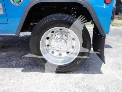 Truck wheel and fender of a blue Ram 4500 SLT showing chrome wheel and tire, fender flare, and mudguard.