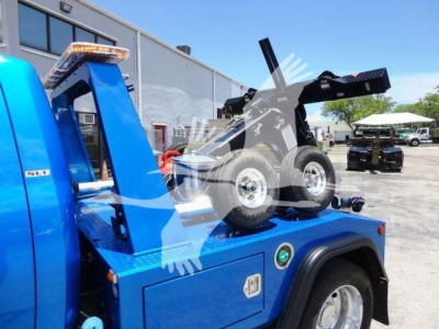 Ram 4500 SLT tow rig with blue engine bay showing winch setup and rear carrier.