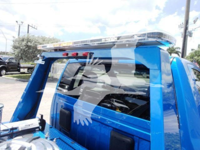 Blue Ram 4500 truck cab with winch equipment and roof light bar visible in the cargo bed area.