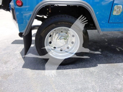 Trunk/bed side of a blue Ram 4500 truck showing wheel with chrome hubcap and fender, rear section and mudguard.