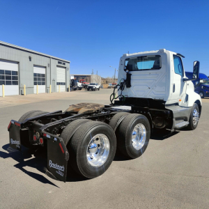 International LT conventional daycab tractor rear view showing chassis, dual rear axles, fuel tanks, and mud flaps with Bruckner's branding