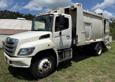 Garbage truck 2015 Hino 338 in serviceable condition showing left-side cab and dump body with stock number 3371-268 and VIN 5PVNV8JL3F4S50297.