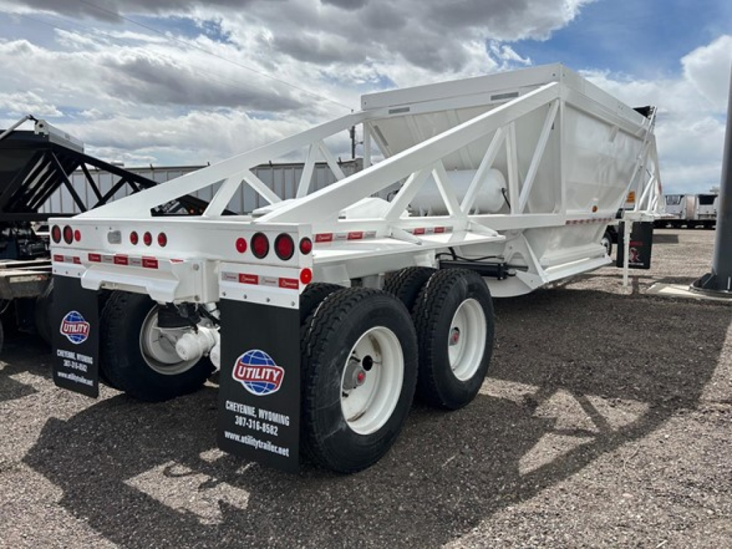 Trailer showing white Ranco air ride bottom dump with dual rear axles and black mud flaps.