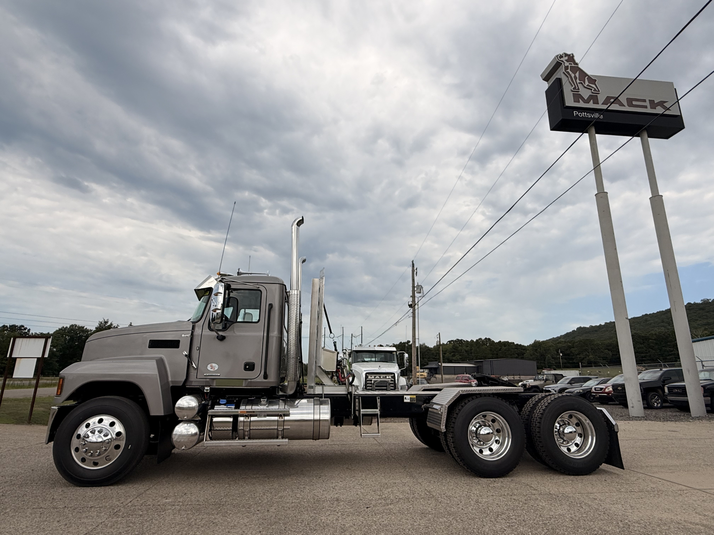 Truck chassis of a new 2027 Mack PI64T conventional daycab showing dual rear axles and fuel tanks.