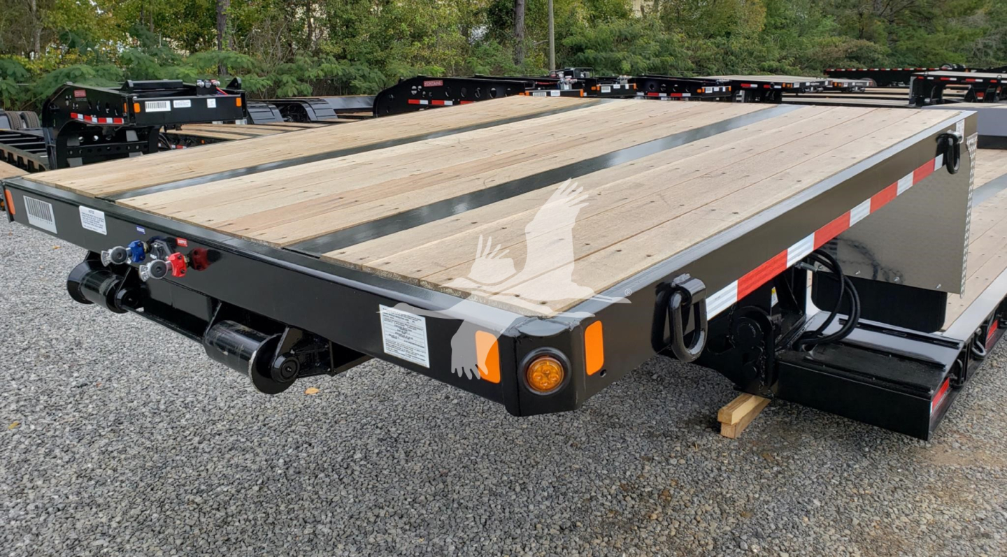Fontaine Renegade double drop expandable trailer showing wooden deck, side safety rails, tail connections, and branding decals.