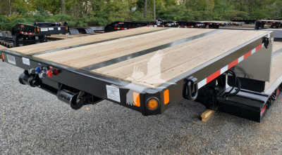 Fontaine Renegade double drop expandable trailer showing wooden deck, side safety rails, tail connections, and branding decals.