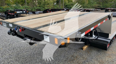 Trailer deck with wooden planks and black frame, rear hitch area with dual-take hoses, safety lights, and white-red reflective tape along edge.
