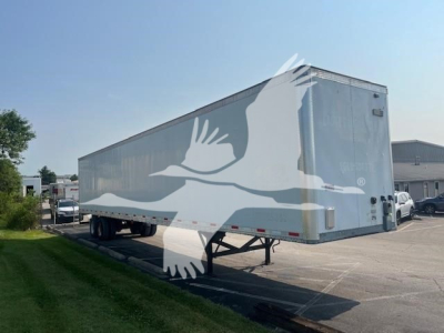 Trailer showing side and rear of a Vanguard Maxcube 2017 utility trailer with a white bird silhouette graphic.
