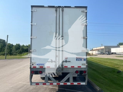Vanguard Maxcube trailer rear view showing dual rear doors, taillights, and bumper; white with rear reflective strips.