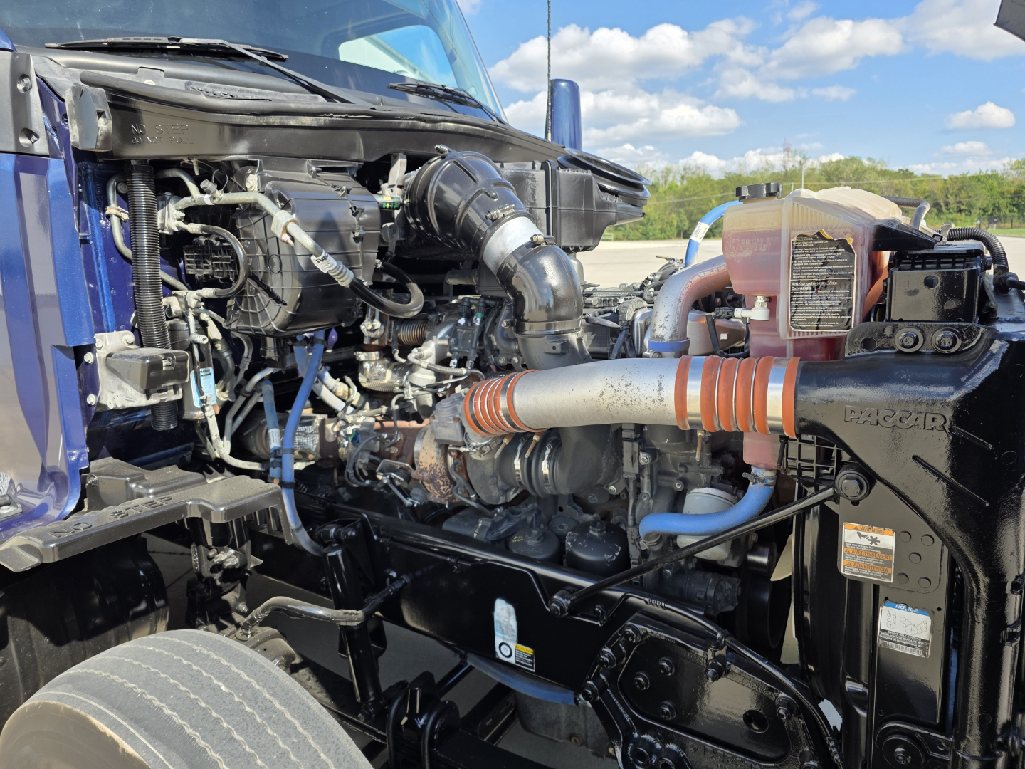 Kenworth T680 engine bay showing turbocharger and intercooler piping with components and hoses visible.