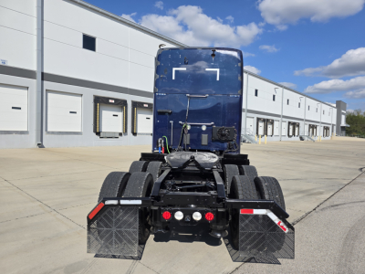 Rear view of a 2018 Kenworth T680 tractor showing dual rear wheels, mud flaps, and fifth wheel area.