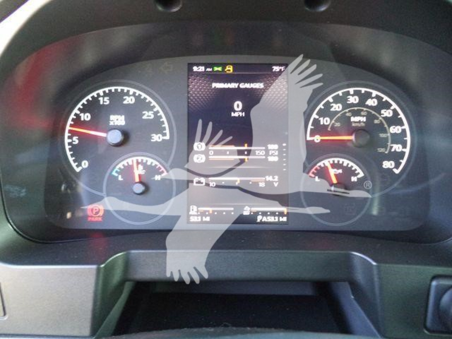 Dashboard of a Kenworth truck showing speedometer, tachometer, and central display with various indicators.
