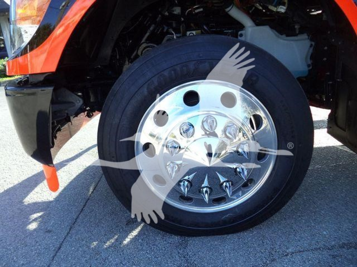 Kenworth T280 front wheel and tire showing polished chrome hubcap and black tire.