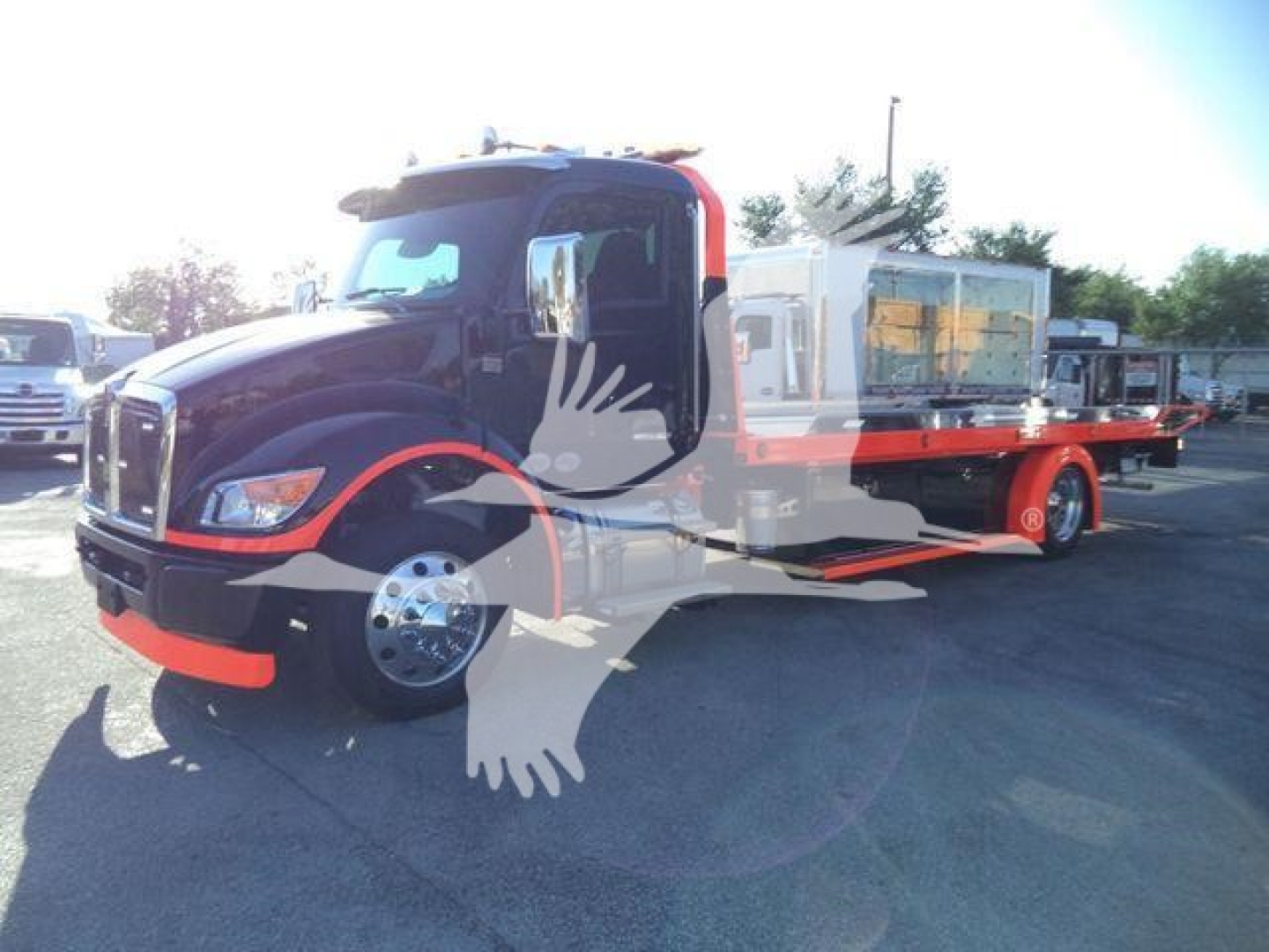Kenworth T280 rollback truck showing front and side with crane winch and flatbed equipment visible.