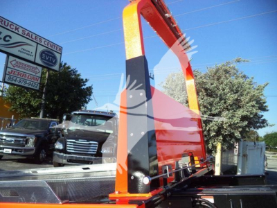 Kenworth T280 rollback truck bed structure with orange and black color, metal frame, and hydraulic lift arms visible.