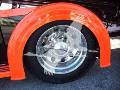 Vehicle wheel and bright orange fender on a 2025 Kenworth T280 rollback truck showing chrome hub and black tire.