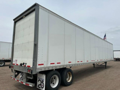 Trailer side view showing 2016 Wabash van box with dual rear wheels and stock number U90904.