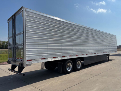 Trailer side view of a 2019 utility refrigerated trailer with metal panel siding, tandem axles, and rear doors.