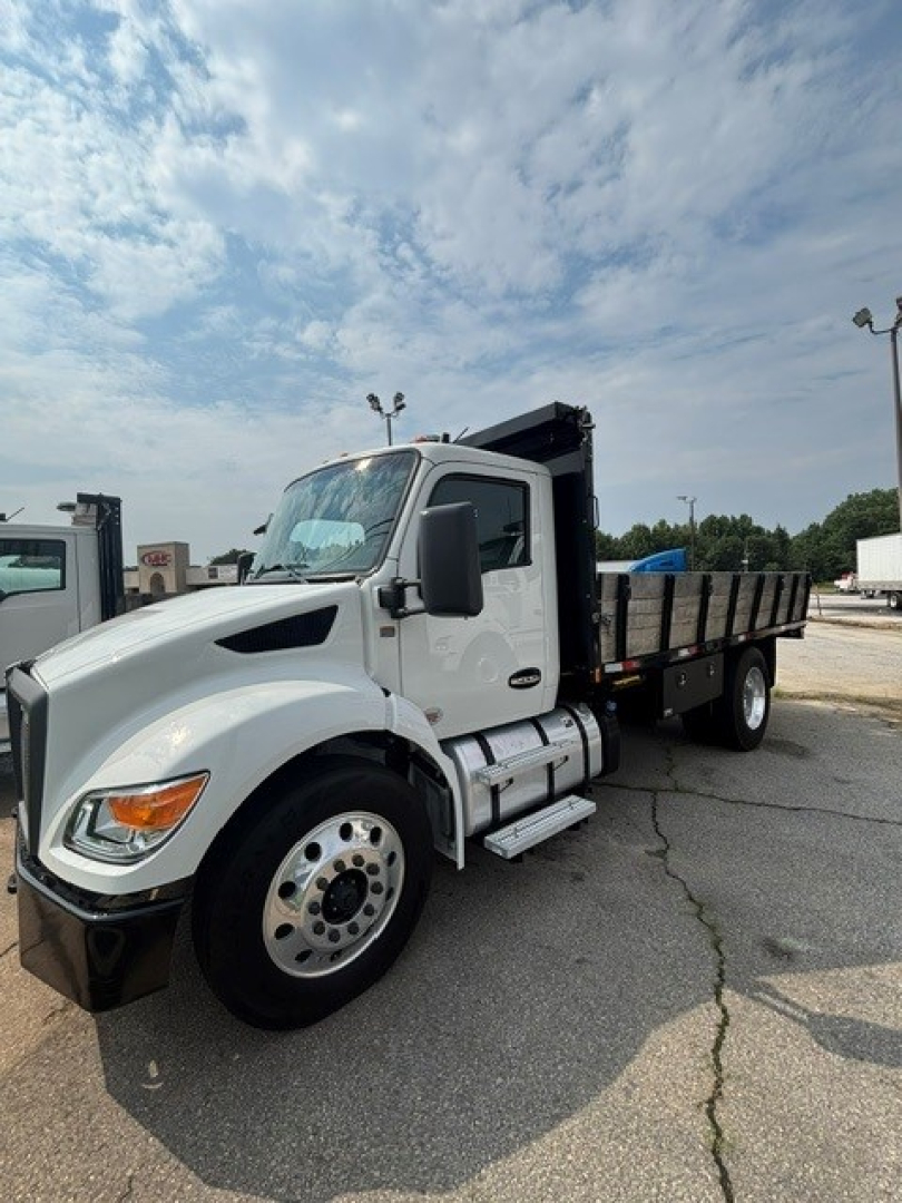 Kenworth T280 cab and chassis truck in a parking lot, front-left view, white with black chassis and dump bed.