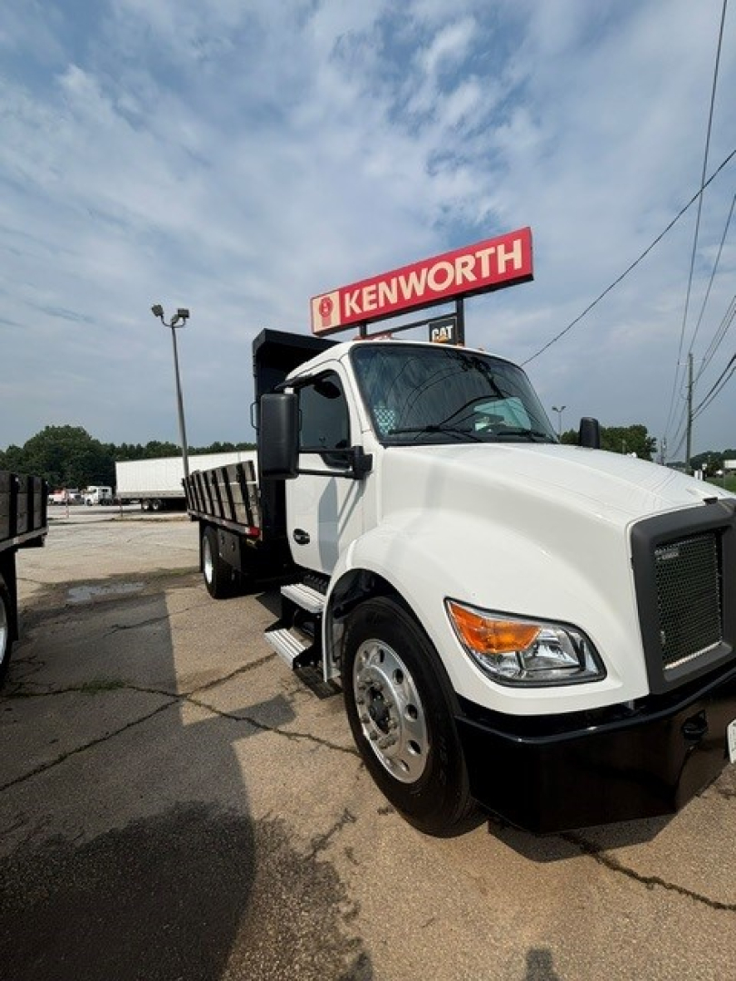Kenworth T280 cab and chassis truck in white with Kenworth sign in background, front-right view.