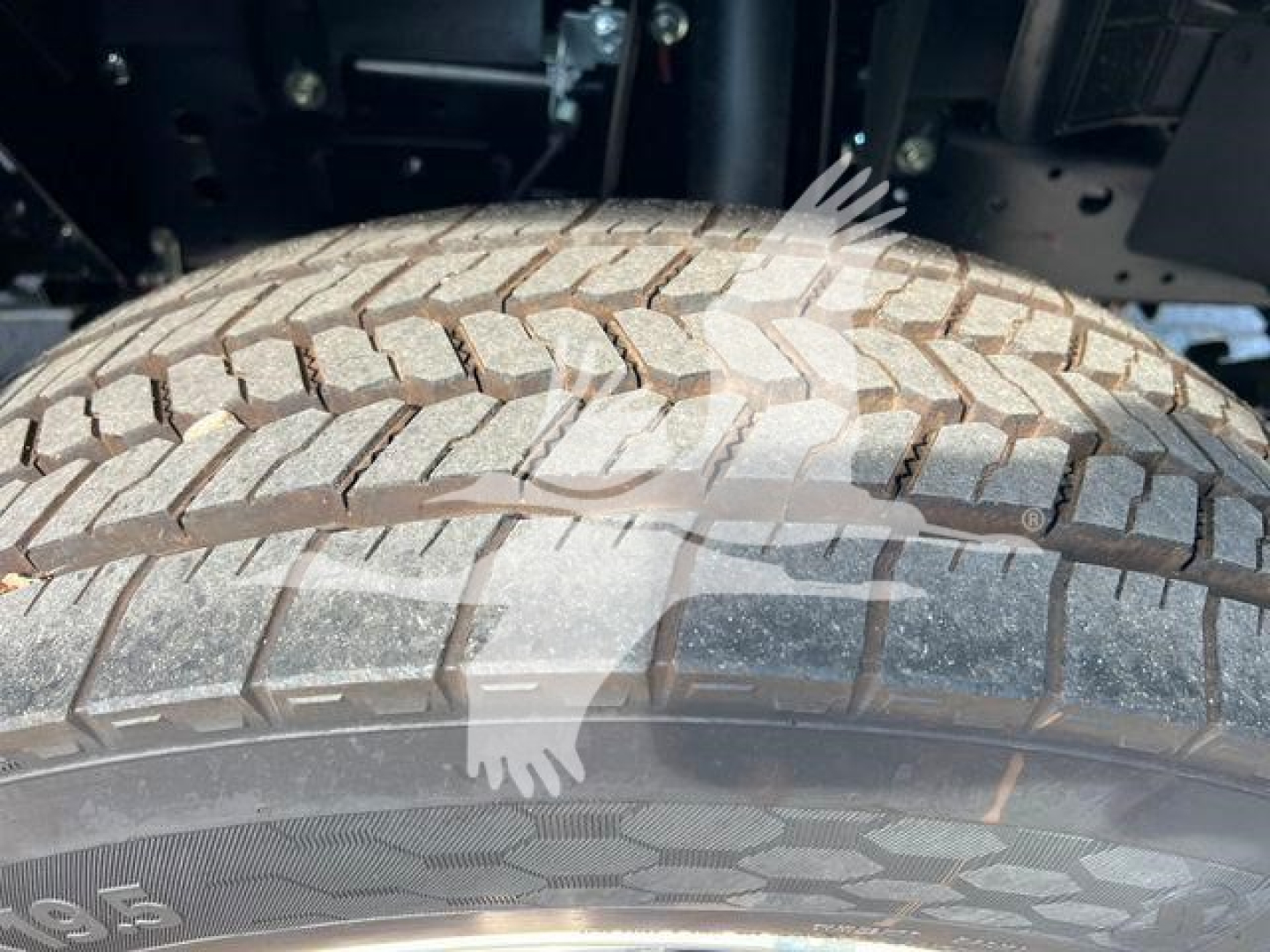 Isuzu NPRR truck wheel and tire close-up showing tread pattern.