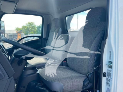 Truck cab interior showing driver seat and passenger seat in Isuzu NPRR; dashboard and steering wheel visible.
