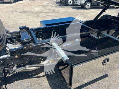 Isuzu NPR/NRR chassis with rollback bed frame visible. No text legible on components in this view.