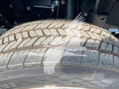 Isuzu NPRR truck wheel and tire close-up showing tread pattern.